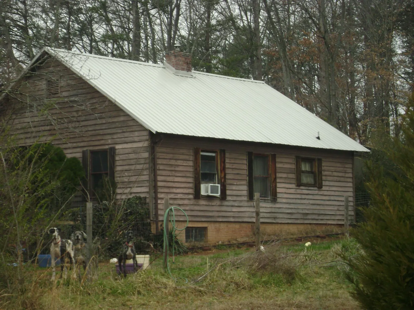 White metal roof on an old wood sided farmhouse, from a Metal Roof Installation job in Center Conway